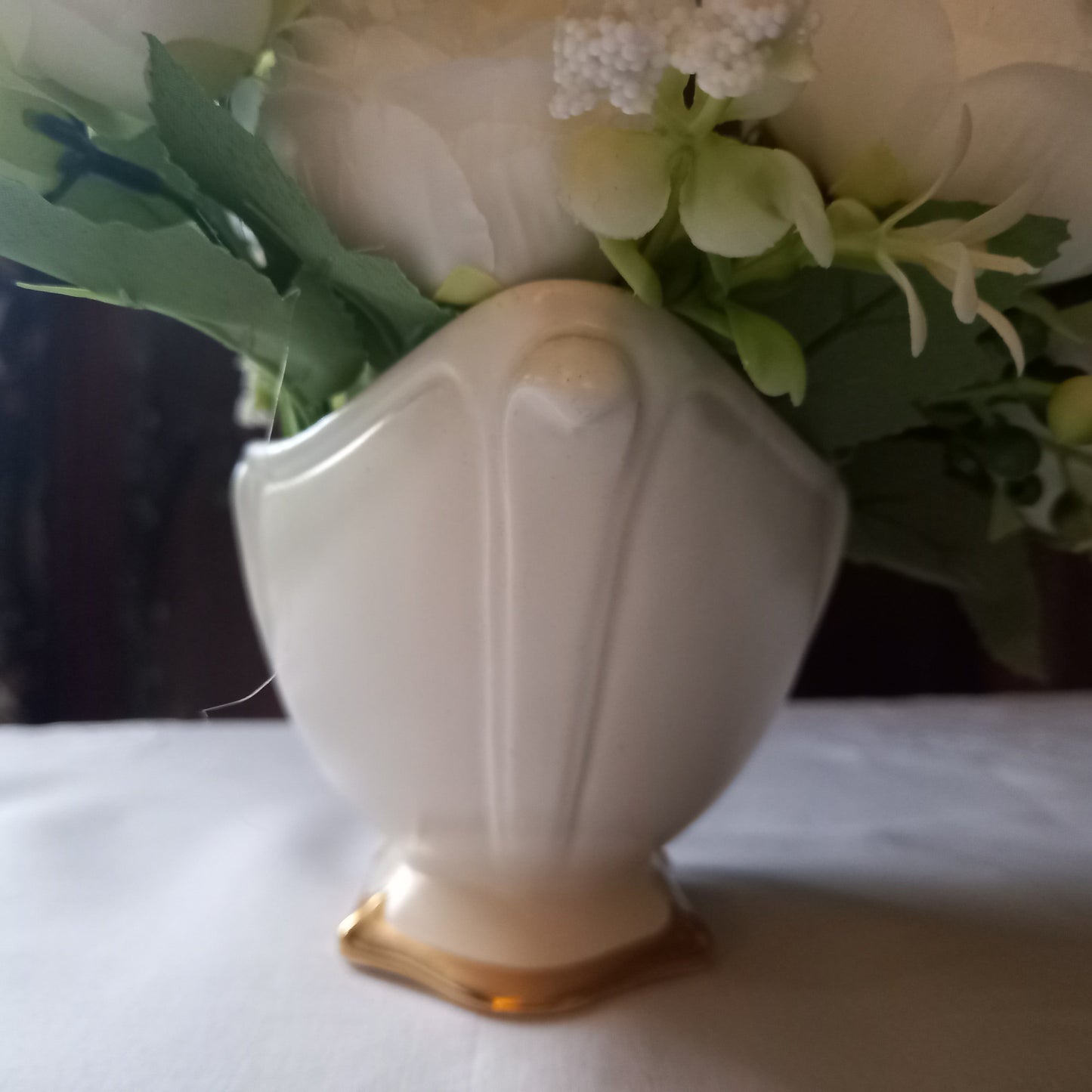 Footed Royal Winton mantle vase in soft ivory glaze, gently scalloped sides with gold base, styled with classic white flowers, shown in close up