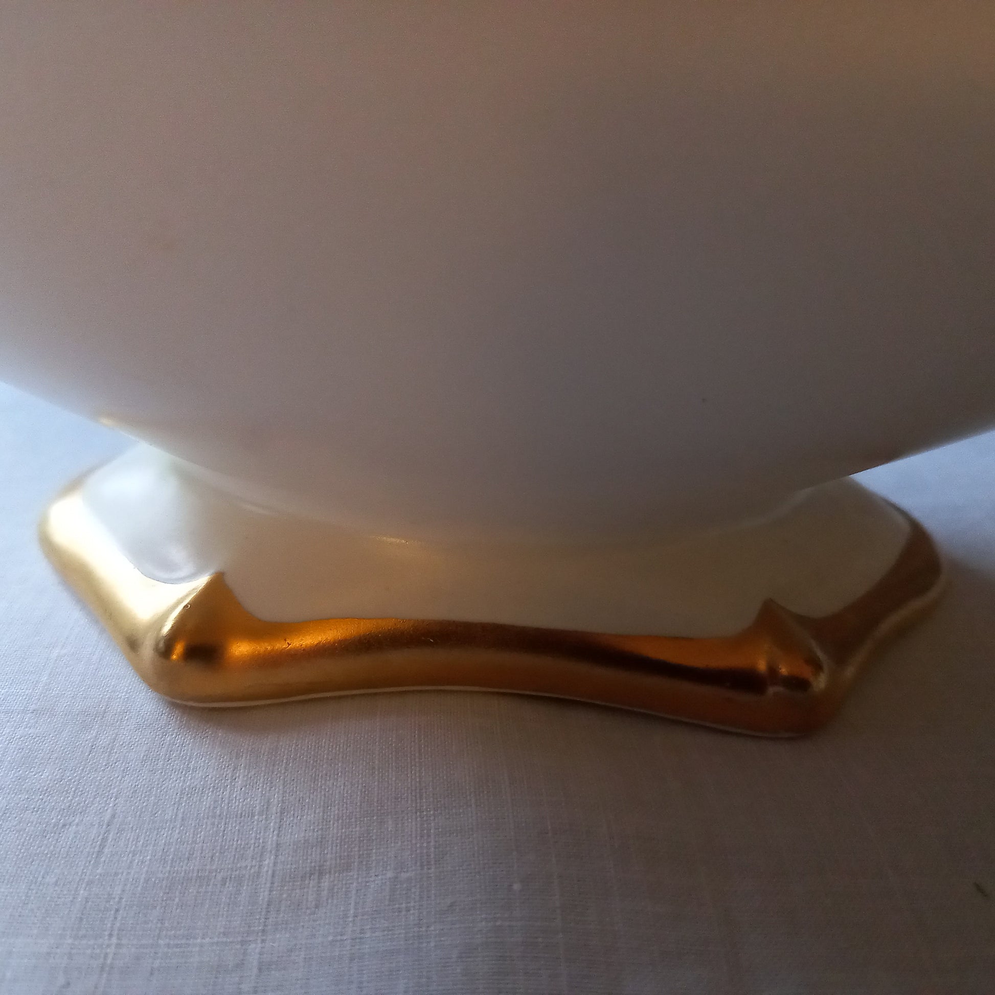 Close-up of Royal Winton Grimwades mantle vase showing sculpted Art Deco style moulding and gold gilt foot detail