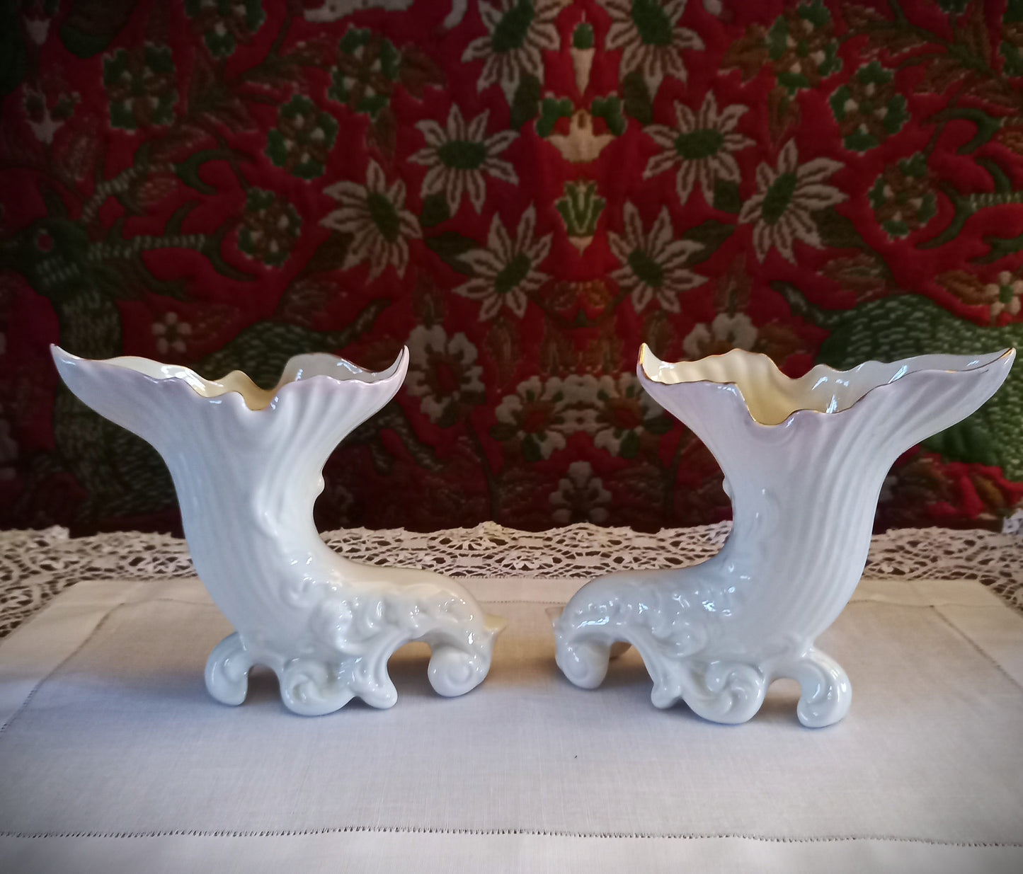 A pair of collectible Belleek spill vases in parian porcelain, buffet and tapestry , are shown empty revealing the delicate fluted rim and scrolled feet