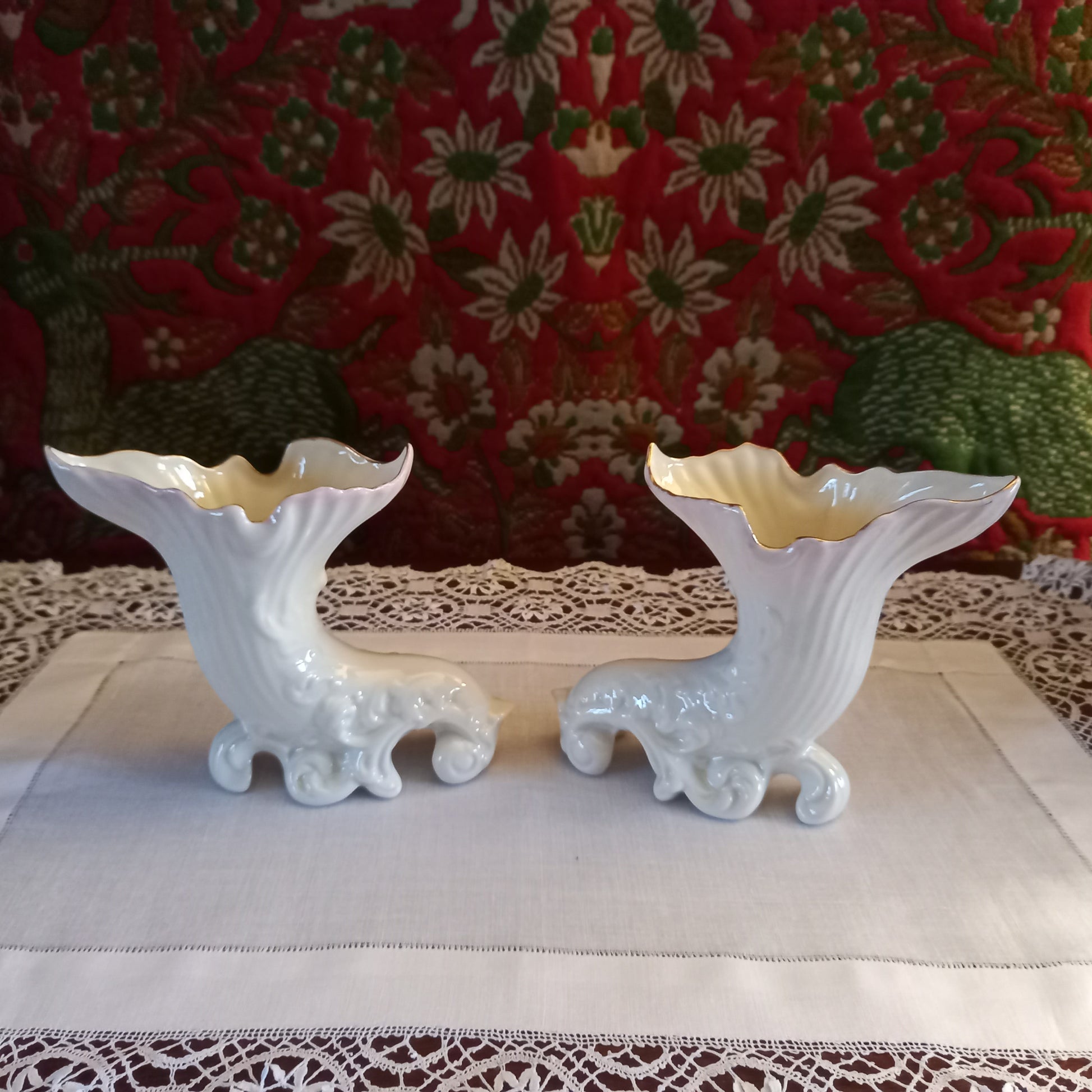 A pair of collectible Belleek spill vases in parian porcelain, buffet and tapestry , are shown empty revealing the delicate fluted rim and scrolled feet