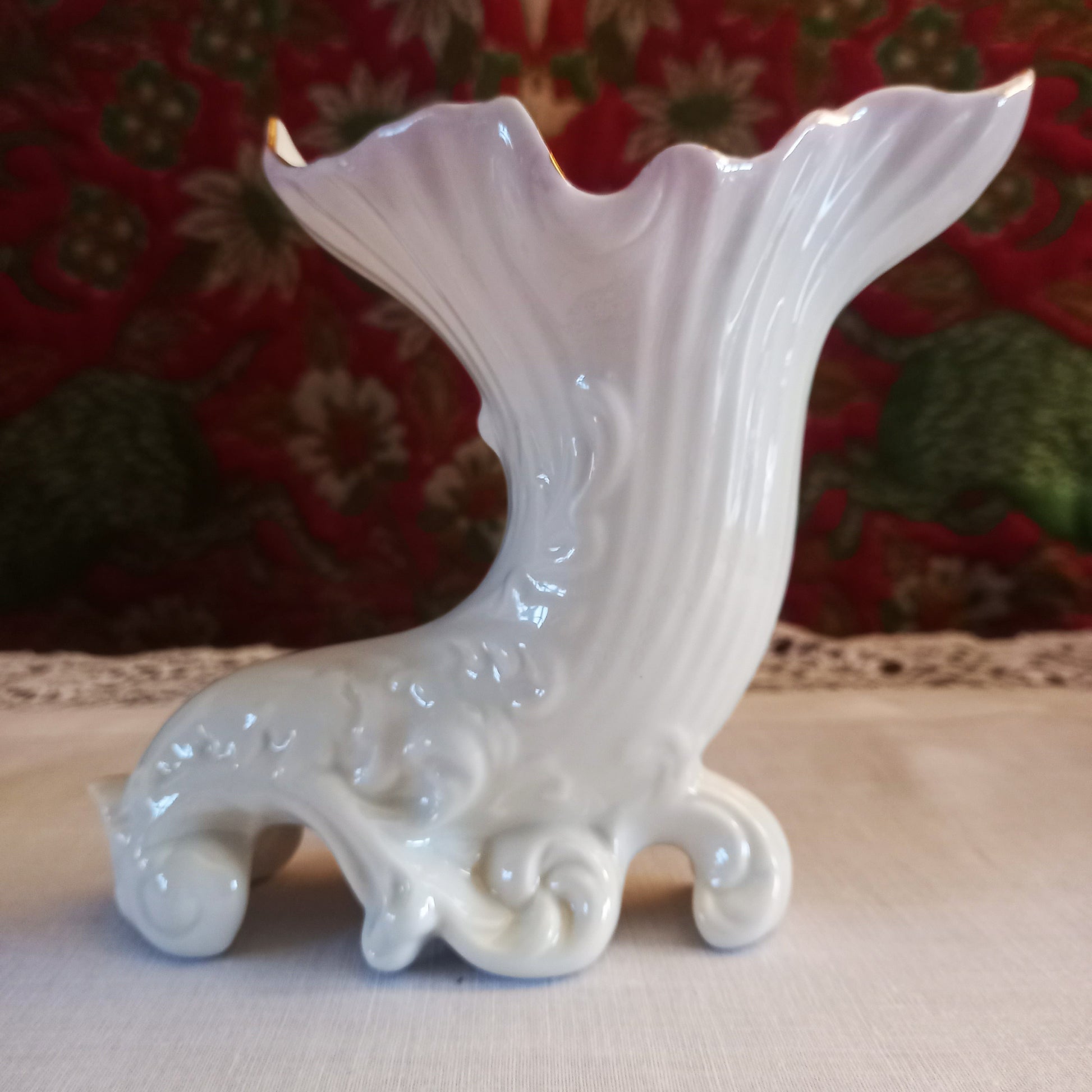 A pair of collectible Belleek spill vases in parian porcelain, buffet and tapestry , are shown empty revealing the delicate fluted rim and scrolled feet