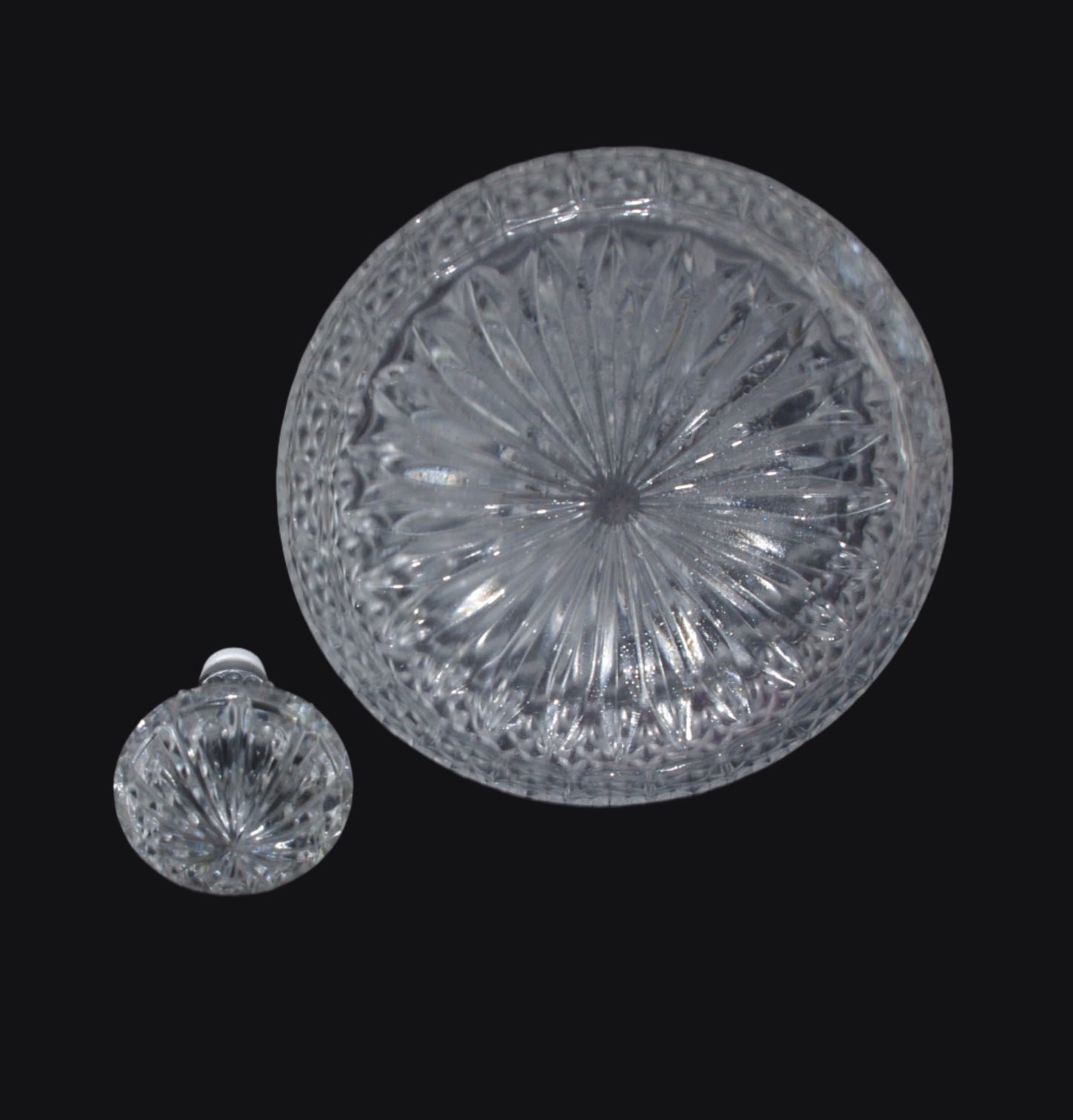 Bottom of Decanter showing intricate cut base, and decanter top by its side