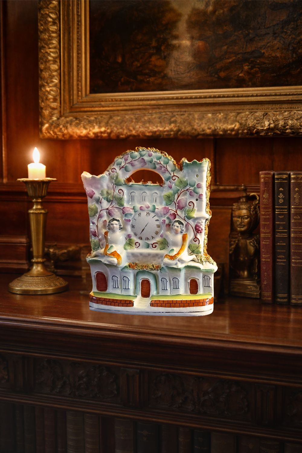 Victorian Staffordshire flatback clock group mantel ornament in glazed earthenware, circa 1850–1875, styled on dark wood library mantel with brass candlestick and antique books