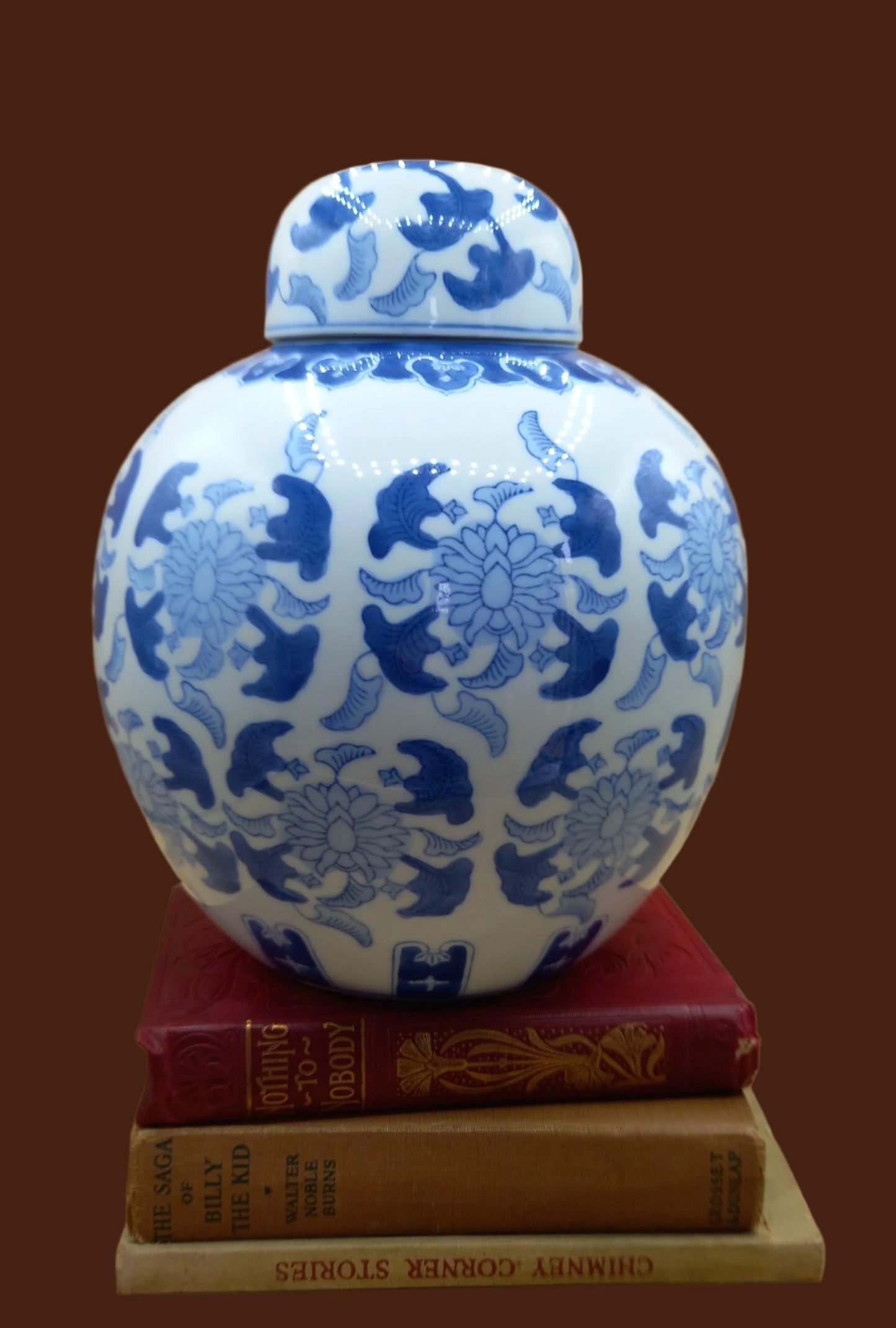 Large Chinoiserie Ginger Jar sits on antique books