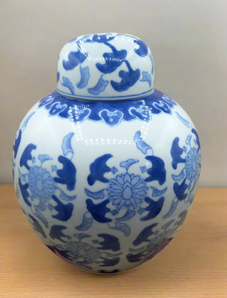Blue and white ceramic jar with intricate patterns on a beige background